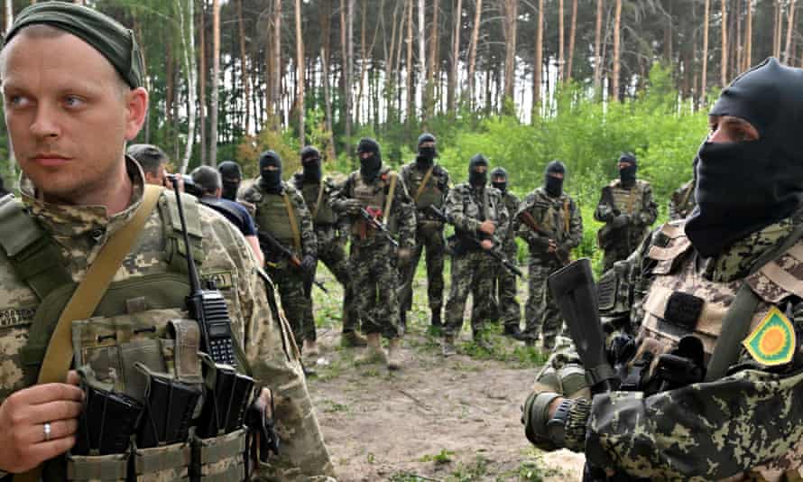 Fighters of the territorial defence unit, a support force to the regular Ukrainian army, take part in an exercise as part of the regular combat tactics classes, not far from the Ukrainian town of Bucha, Kyiv region on June 17, 2022.