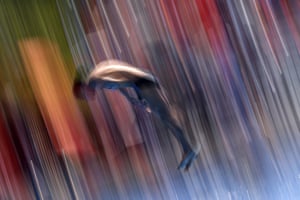 A blurred photo of a diver flying through the air