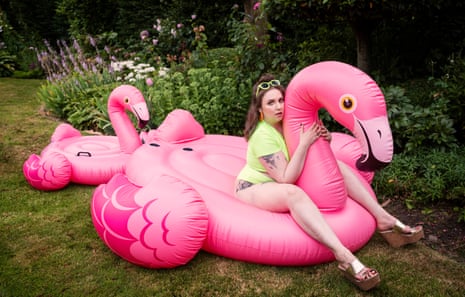 Lena Dunham photographed in Wales, July 2019, sitting on an inflatable pink flamingo