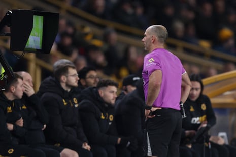 Referee Tim Robinson looks at the pitch side monitor during a VAR review after Nottingham Forest's Igor Jesus put the ball into the net.