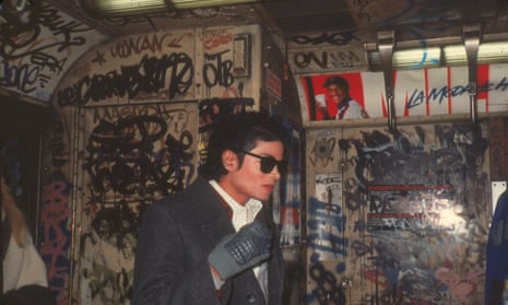 Michael Jackson stands in a graffiti-filled subway car during the filming of the music video for Bad, directed by Martin Scorsese.