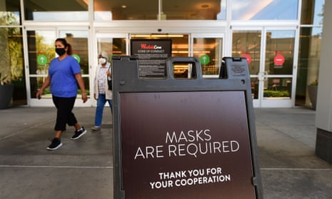 A shopping mall in southern California reminds patrons to wear face masks as the state reopens businesses.