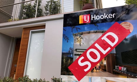 A sold sticker attached to a real estate agent's sign outside the front of a residential property in central Sydney