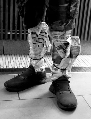 a man wearing newspaper around his ankle