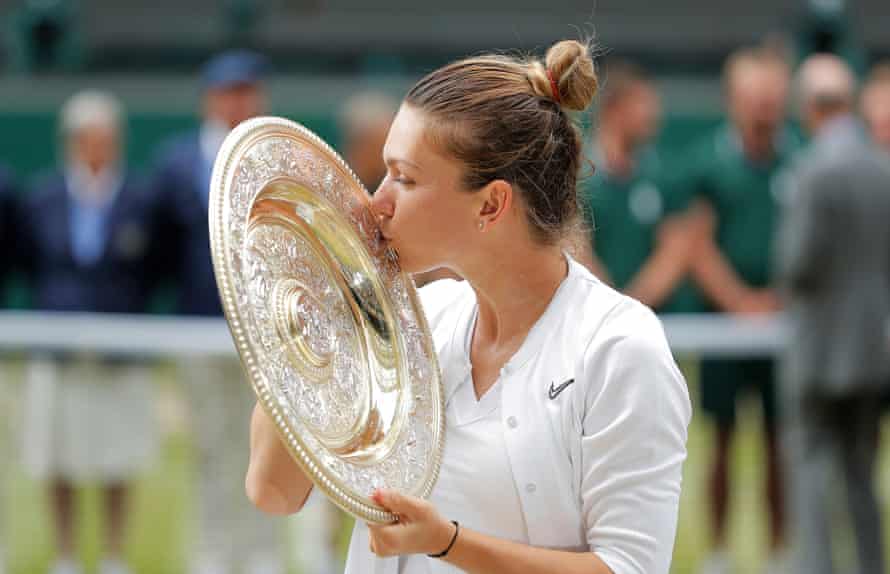 Halep poses with the spoils of her victory.