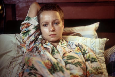 Morton sitting in bed in colourful pyjamas in a still from the 2002 film In America.