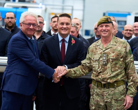 Armin Papperger, Wes Streeting and Gen Sir Roland Walker all shake hands together.