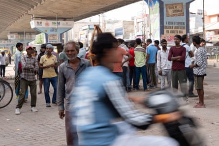 Daily-wage labourers wait at Badshahpur market, Gurgaon, to be picked by contractors for construction work.