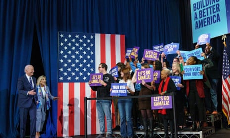 Joe and Jill Biden with supporters in front of an American flag.