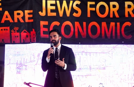 a man in a suit speaks into a microphone