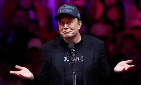 a man black clothing smirks with his hands outstretched