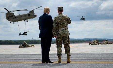 US President Donald Trump (L) watches an air assault exercise with Army Major General Walter Piatt at Fort Drum, New York