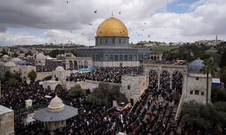 Muslims perform Friday prayers during Ramadan on 31 March 2023 outside the Dome of Rock shrine.