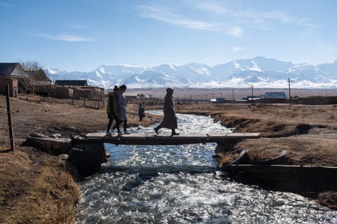 Buunisa Termechikova crosses the river in Sary-Mogol on her way home to Burgan-Suu village, Kyrgyzstan.