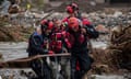 Rescue workers evacuate people across a flooded street in Jesenik, Czech Republic.