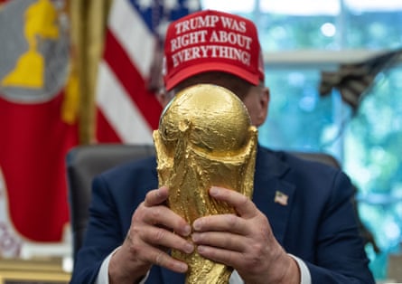Donald Trump holds the World Cup trophy in the Oval Office