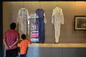 People look at hazmat suits signed and donated by medical teams from Guangdong and Hainan who supported Hubei province during the lockdown, displayed in a room of the Wuhan Revolution Exhibition