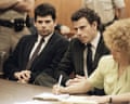two men in suits sit in a courtroom