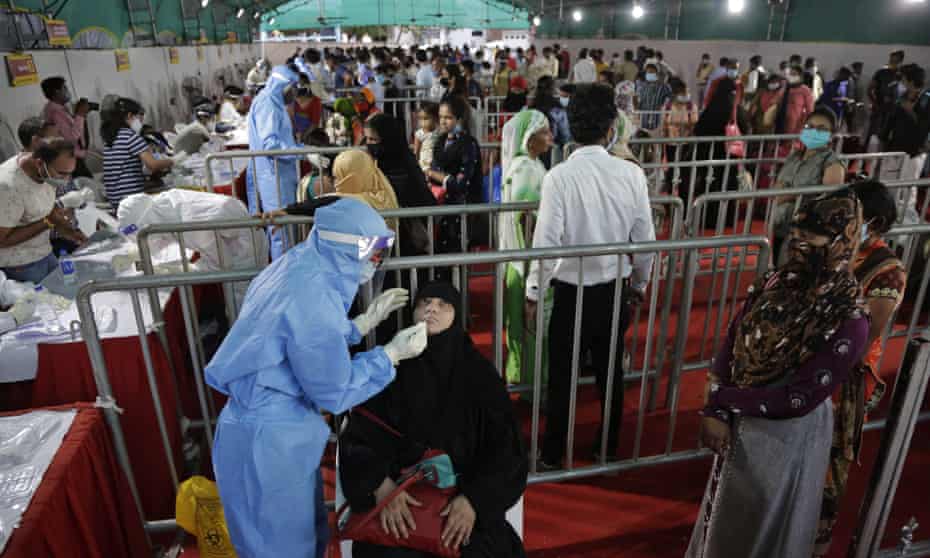 A health worker takes a nasal swab at a Covid-19 facility in Ahmedabad.