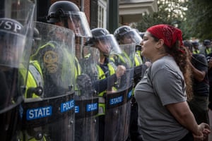 A woman speaks to riot police