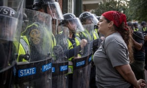 A demonstrator at UVA asks riot police to leave on the University of Virginia campus during protests in Charlottesville, Virginia, on Saturday.