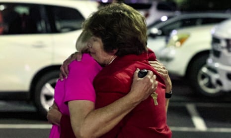 Church attendees console each other after the deadly shooting.