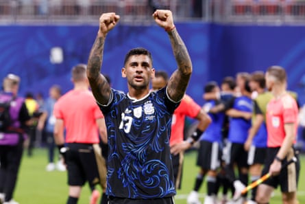 Cristian Romero lifts his arms aloft towards the crowd at the full time whistle.
