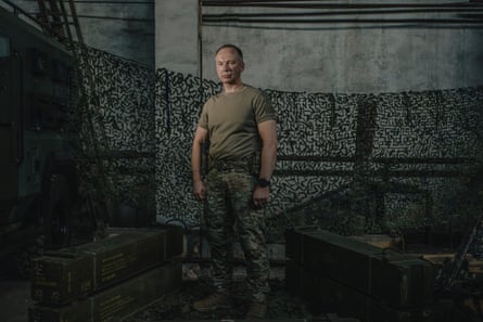 Oleksandr Syrskyi posing against a military drape