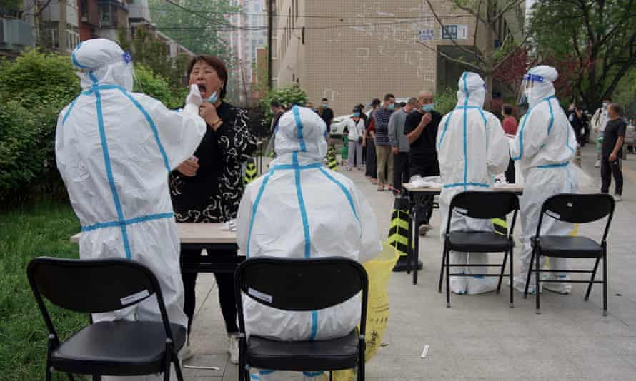 Beijing residents undergo testing for Covid-19 at a swab collection site on Monday as Chinese authorities rushed to stamp out an outbreak ini the capital.