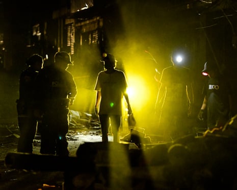 Volunteers help remove debris at a collapsed building in Pereira, western Colombia