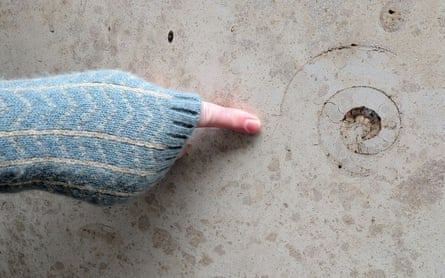 Ruth Siddall pointing at an ammonite on Plantation Lane.