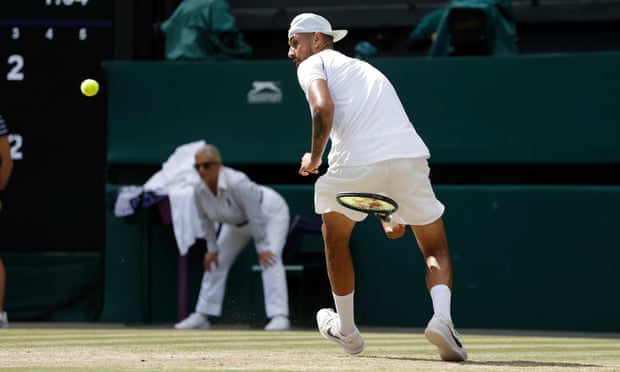 Nick Kyrgios plays a shot between his legs