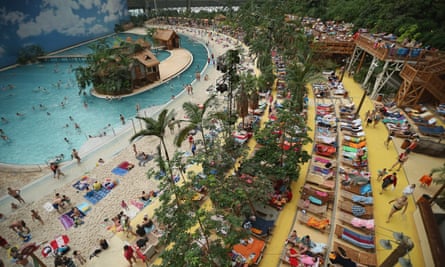 Visitors relax at the beach in the indoor Tropical Islands theme park, Krausnick, Germany