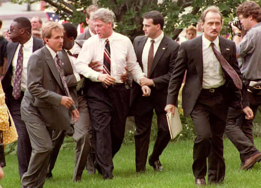 Then-Democratic presidential candidate Bill Clinton escorted by US secret service agents in July 1992 after an anti-abortion protester moved towards the Arkansas governor during a Ohio rally.
