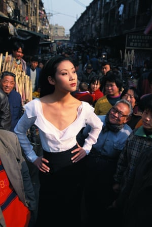 A Shanghai model, Yao Shuyu, strikes a airs successful a Dior formal successful the mediate of a engaged street, 1996