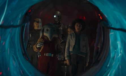 They stand at the entrance of a blue tunnel