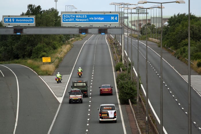 Police escort vehicles along the M4 motorway during the morning rush hour as drivers hold a go-slow protest on the M4.
