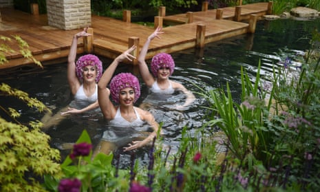 Members of the Aquabatix synchronised swimming group perform in the M&amp;G garden at the Chelsea flower show. 