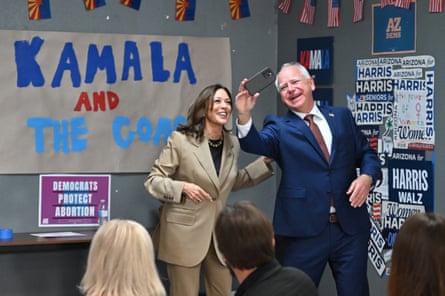 pair smile as walz holds up phone