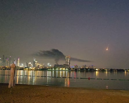 Smoke rises over a hotel damaged in Dubai’s famed Palm Jumeirah, in Dubai.
