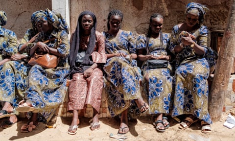 A group of women rest on a side street in the Yoff district of Dakar