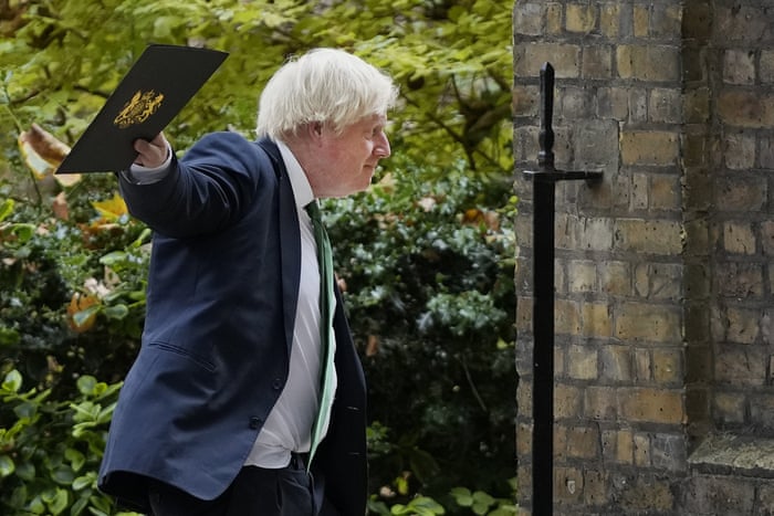 Boris Johnson waves to reporters on his way to a virtual conference on Ukraine today.