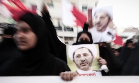 Protesters in Manama carry photographs of Sheikh Ali Salman