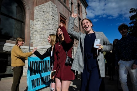 Young people raise their fists when they arrive at court.