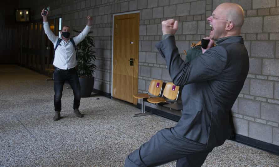 Donald Pols, right, the director of Milieudefensie – the Dutch arm of Friends of the Earth – celebrates the outcome of the verdict in the court case against Shell in The Hague.