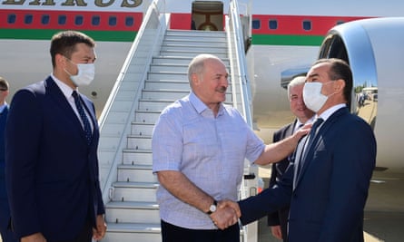 The Belarusian president, Alexander Lukashenko, greets officials during a welcoming ceremony upon his arrival at an airport in Sochi, Russia.