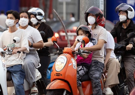 People wearing protective in Chiang Mai on mopeds