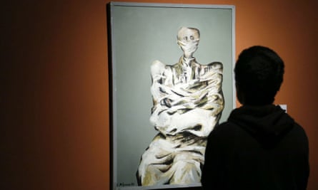 A visitor at the Tehran museum of contemporary art looks at a work by Bahman Mohasses
