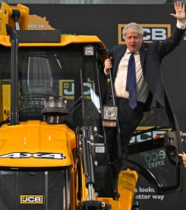 Britain's Prime Minister, Boris Johnson, shakes hands with an excavator during his visit to the JCB factory in Vadodara this year.