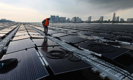 A worker on a floating solar power farm, off Singapore’s northern coast, 22 January 2021.